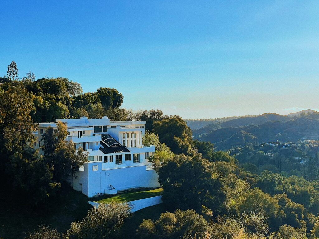 Modern White Mansion In The Hills With Large Windows, a Glass-Roof Atrium, And Panoramic Mountain Views