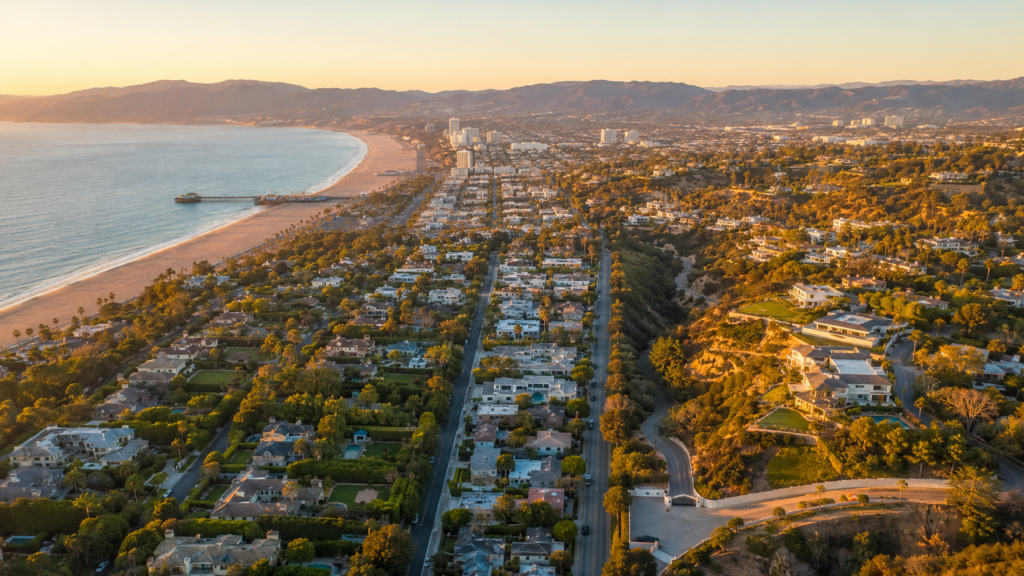 Aerial View Of Santa Monica Coastline And Bel Air Hillside Estates At Sunset.